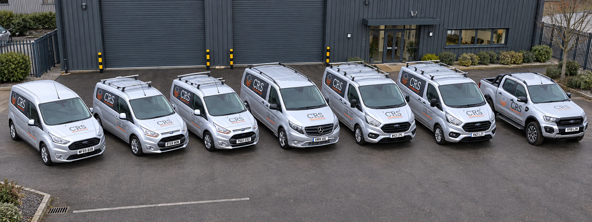 CRS fleet composite showing six vans and a pickup truck